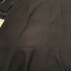 Black fitted dress with ruffles on the bottom very cute